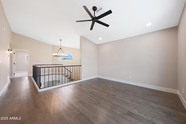 7535 W Kimberly Way, Glendale, AZ 85308 - unfurnished room featuring a chandelier, dark wood-type flooring, vaulted ceiling, ceiling fan, and baseboards
