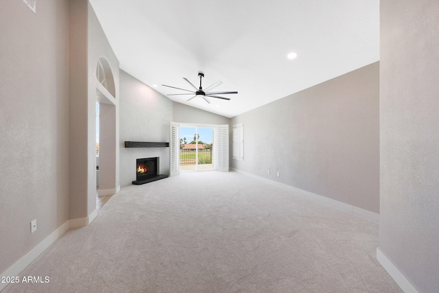 7535 W Kimberly Way, Glendale, AZ 85308 - unfurnished living room with ceiling fan, carpet floors, vaulted ceiling, a warm lit fireplace, and baseboards