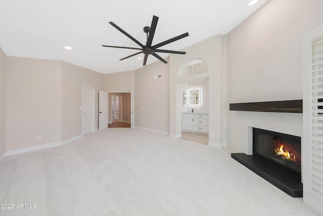 7535 W Kimberly Way, Glendale, AZ 85308 - unfurnished living room featuring a glass covered fireplace, recessed lighting, ceiling fan, carpet flooring, and vaulted ceiling
