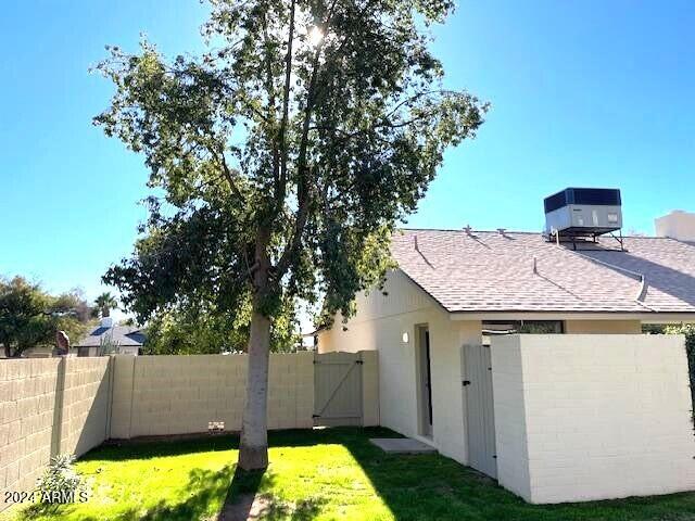 exterior space with a yard and central air condition unit