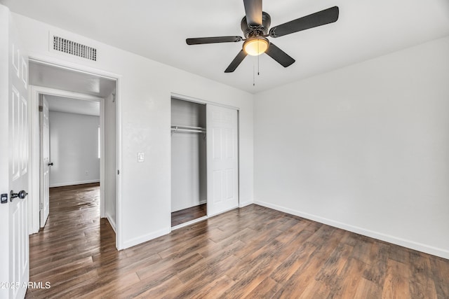 unfurnished bedroom with visible vents, baseboards, wood finished floors, a closet, and a ceiling fan