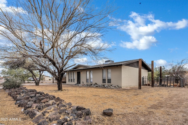 view of side of home with fence