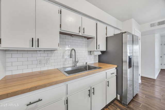 kitchen with tasteful backsplash, dark wood-style flooring, white cabinets, and a sink