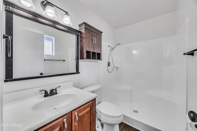 bathroom with a shower, toilet, and vanity