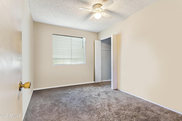 unfurnished bedroom with ceiling fan, carpet floors, a textured ceiling, and a closet