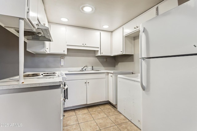 kitchen with sink, light tile patterned floors, white cabinets, and white appliances