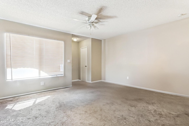 carpeted empty room with ceiling fan and a textured ceiling