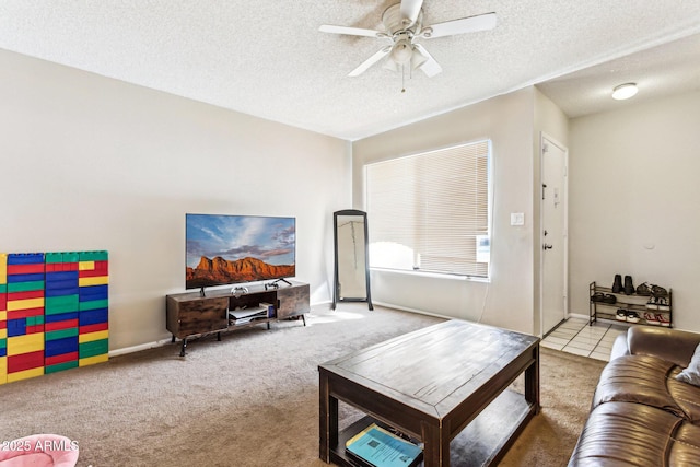 carpeted living room with ceiling fan and a textured ceiling