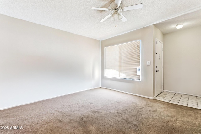 unfurnished room featuring ceiling fan, carpet floors, and a textured ceiling