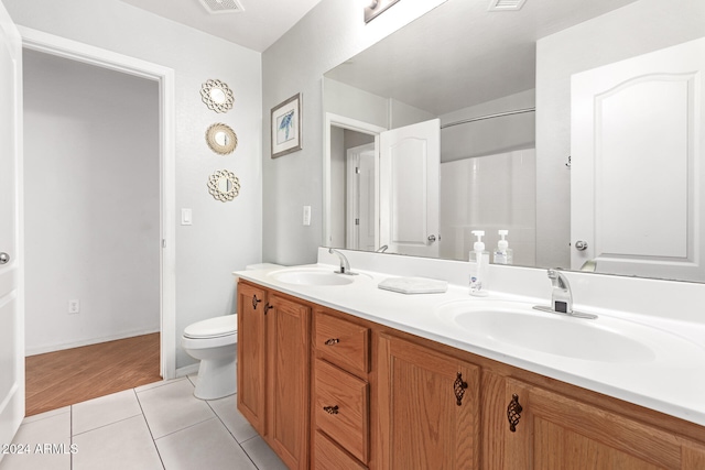 bathroom featuring toilet, vanity, and tile patterned floors