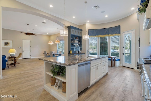 kitchen with a center island with sink, stainless steel dishwasher, white cabinets, and light hardwood / wood-style floors