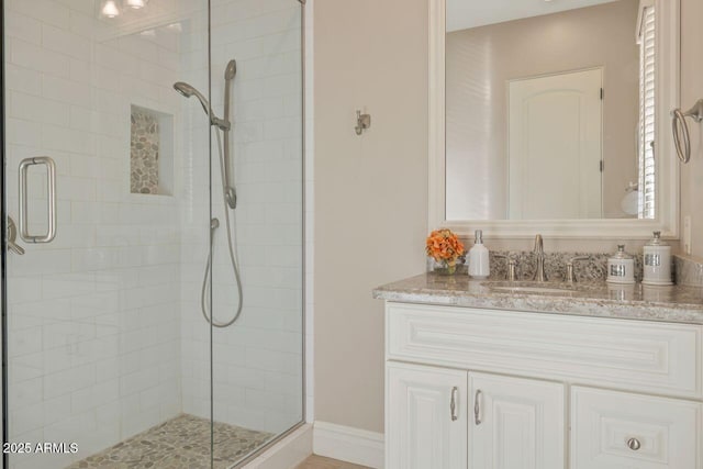 bathroom featuring vanity and an enclosed shower