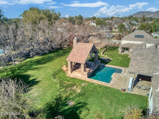 exterior space with a patio, a mountain view, and a lawn