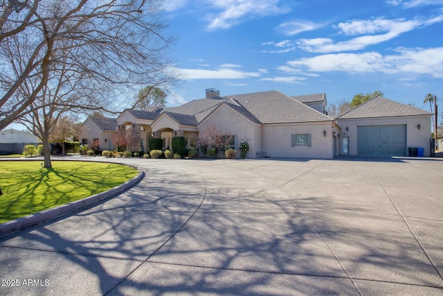 view of front of property with a garage and a front yard