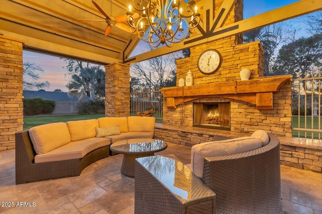 patio terrace at dusk with an outdoor living space with a fireplace