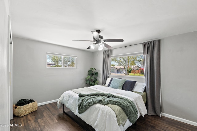 bedroom with baseboards, wood finished floors, and ceiling fan