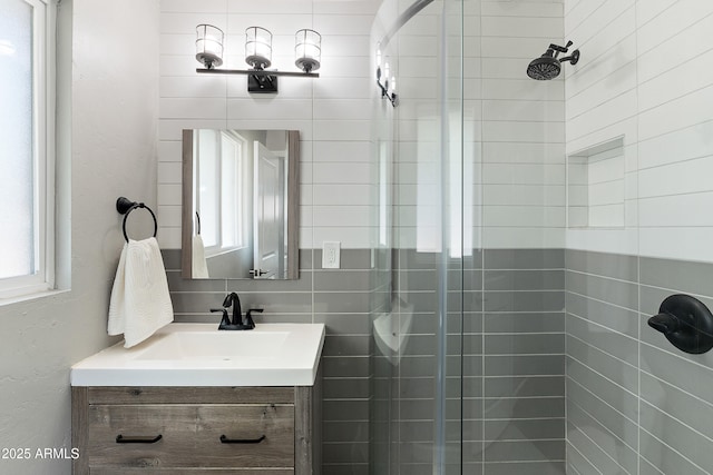 bathroom with a stall shower and vanity