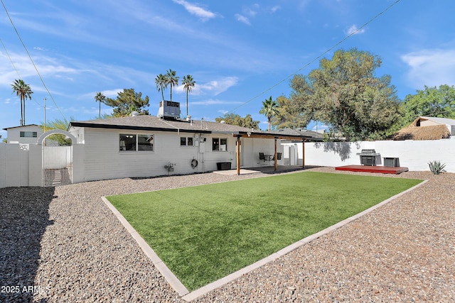 rear view of property with central air condition unit, a patio area, and a gate