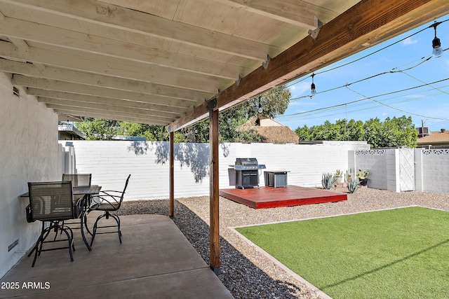 view of patio / terrace featuring a wooden deck, a grill, and outdoor dining area