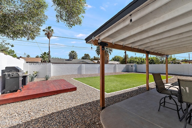 view of patio with grilling area, a deck, outdoor dining area, a storage unit, and an outbuilding