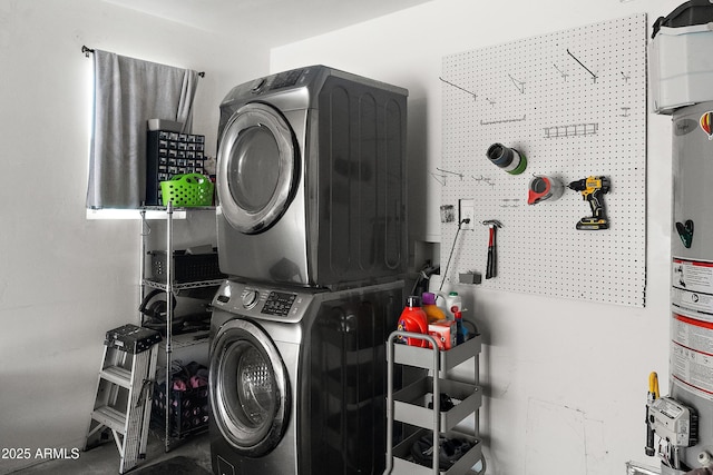 washroom featuring stacked washer / dryer and a workshop area
