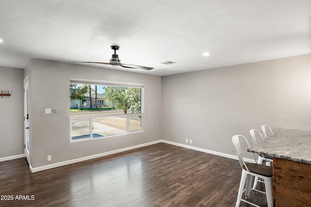 unfurnished dining area with ceiling fan, baseboards, dark wood-style floors, and recessed lighting