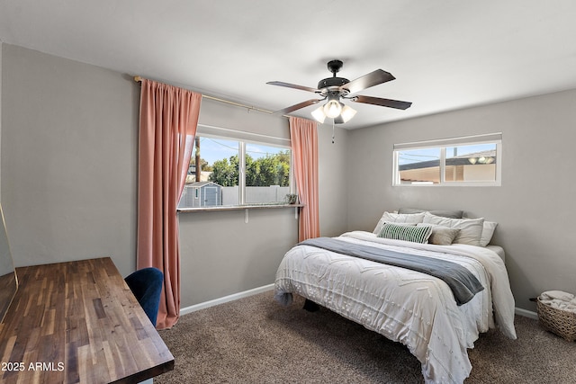 bedroom with multiple windows, carpet, baseboards, and a ceiling fan