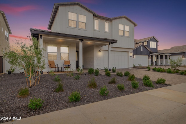 view of front of property with a porch and a garage