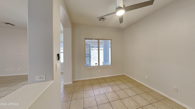 unfurnished room with light tile patterned floors and ceiling fan