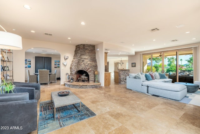 living room with a stone fireplace