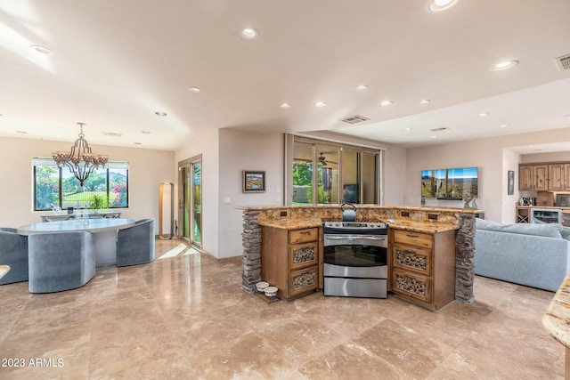 kitchen featuring light stone counters, a notable chandelier, hanging light fixtures, and electric stove