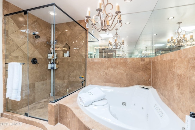 bathroom featuring tile walls and independent shower and bath