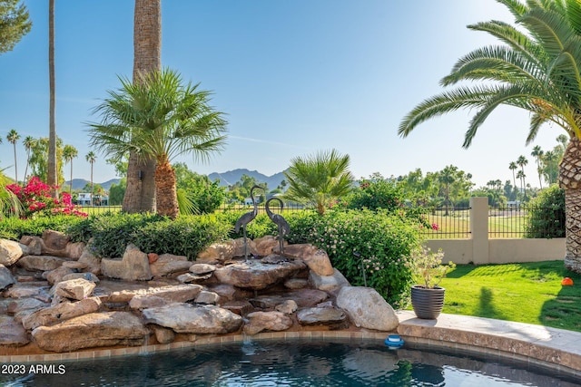 view of pool featuring a mountain view and a lawn