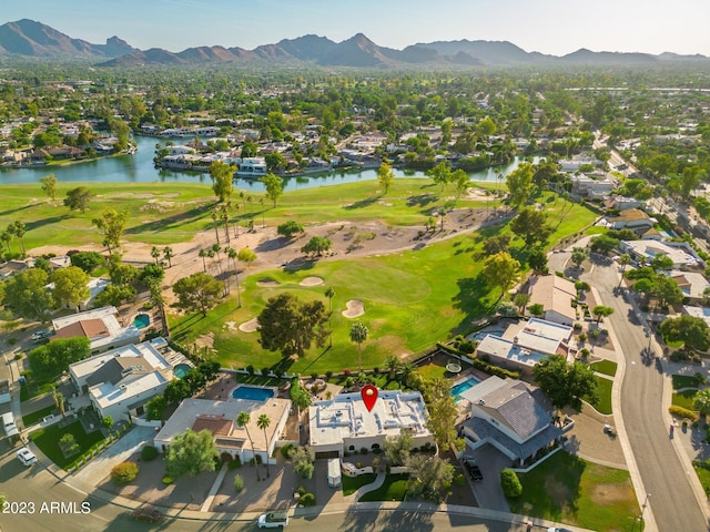 birds eye view of property featuring a water and mountain view