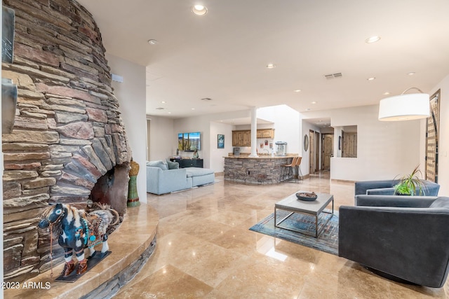 living room with a stone fireplace