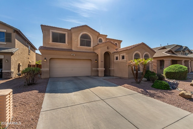 mediterranean / spanish-style house featuring a garage