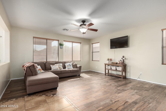 living room featuring ceiling fan and hardwood / wood-style floors