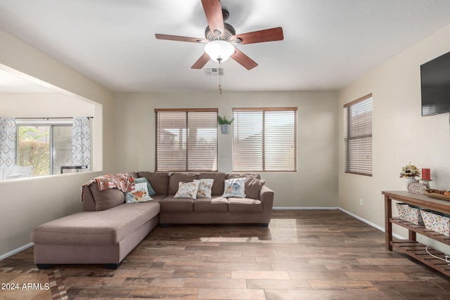 living room featuring ceiling fan and dark hardwood / wood-style flooring