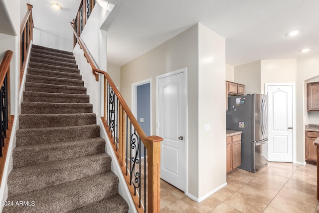 staircase featuring tile patterned floors