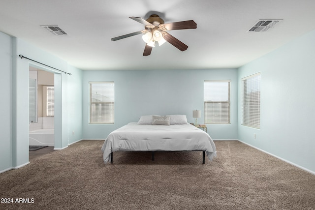 carpeted bedroom featuring ceiling fan and ensuite bathroom