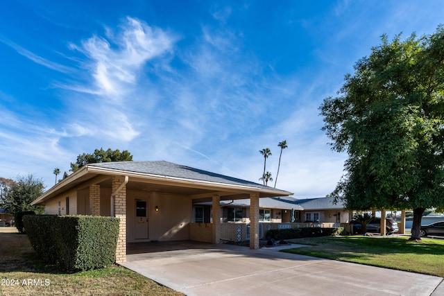 exterior space featuring a carport and a yard