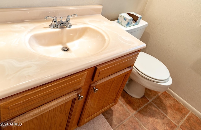 bathroom featuring tile patterned flooring, vanity, and toilet