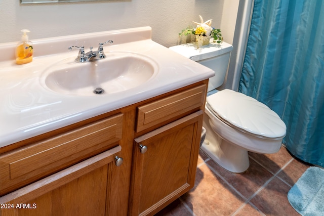 bathroom featuring tile patterned flooring, vanity, and toilet