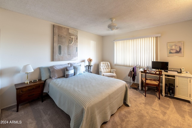 bedroom featuring carpet flooring, ceiling fan, and a textured ceiling