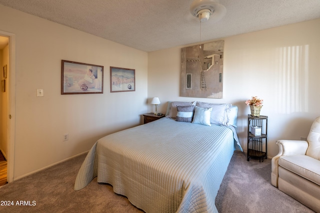 bedroom with a textured ceiling and carpet floors