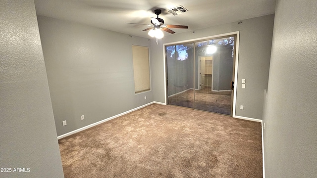 carpeted spare room with ceiling fan