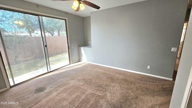 carpeted spare room featuring ceiling fan