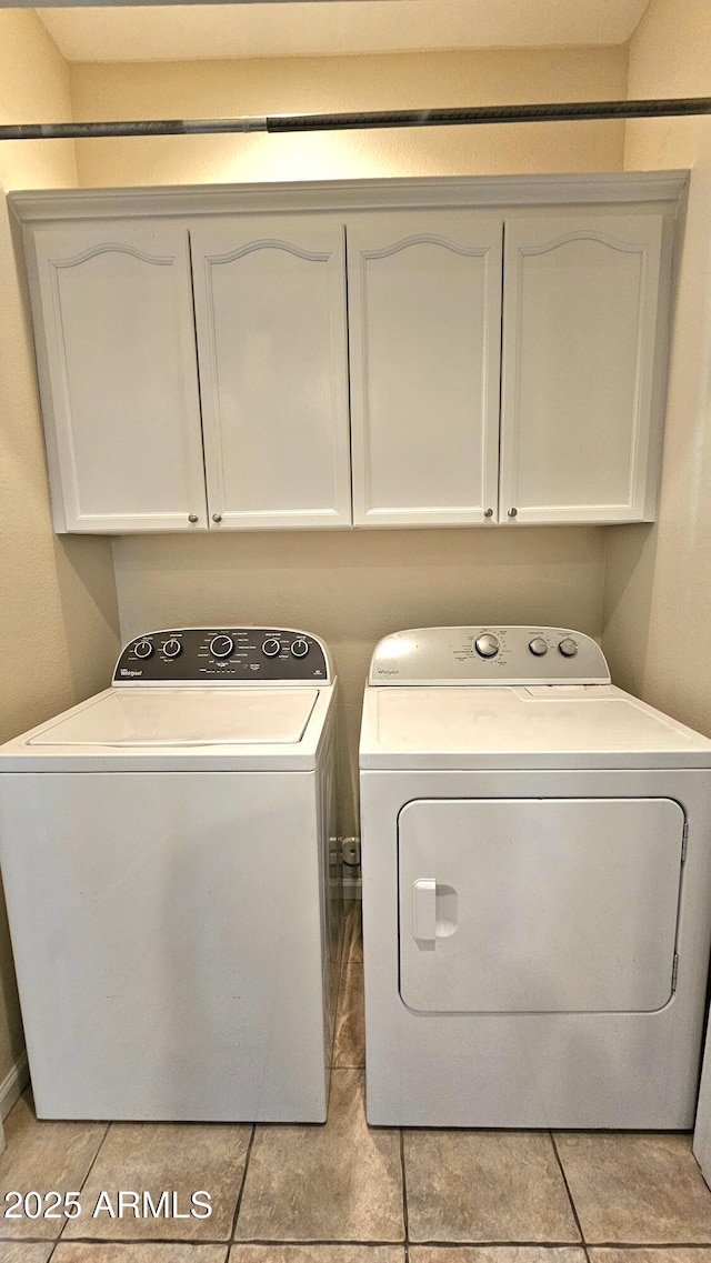 washroom with cabinets, light tile patterned floors, and separate washer and dryer