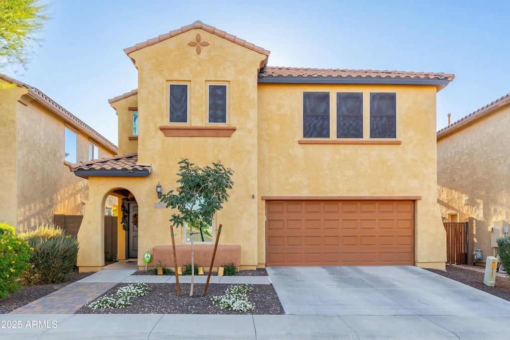 mediterranean / spanish-style house with a garage