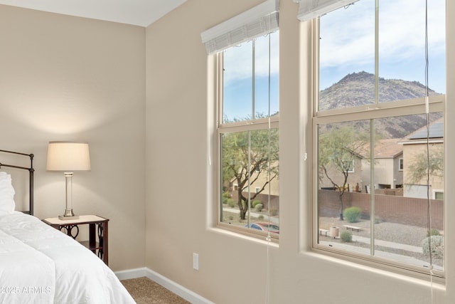 bedroom featuring a mountain view and carpet floors